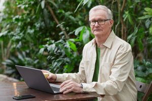 estate planning, image of middle-aged man using a laptop outdoors