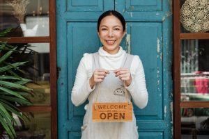 estate planning, image of store owner holding a sign