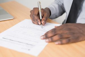 will in Louisiana, image of hands signing a document