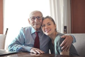 need a will, image of senior man and with arm around a young woman