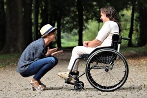 special needs planning, image of smiling woman talking with woman in a wheelchair